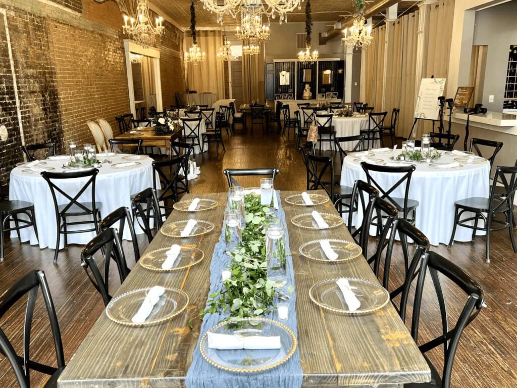 Gather McKinney venue with long wooden table and numerous round tables